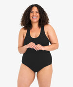 A woman wearing the WUKA Scoop Back Period Swimsuit - Light/Medium Flow. 