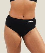 Close-up of WUKA Seamless Midi Brief period underwear worn by a model, showing the smooth fabric finish and full coverage designed for leak-proof protection.