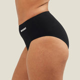 Side view of a model wearing WUKA Seamless Midi Brief period underwear, showing the stretch fit across the hips and the smooth, body-contouring shape.