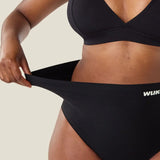 Woman stretching the waist on the Wuka seamless stretch high waisted period pants