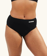 Close-up of WUKA Seamless Midi Brief period underwear worn by a model, showing the smooth fabric finish and full coverage designed for leak-proof protection.