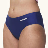 Side of model wearing the Wuka stretch teen midi brief seamless period pants in blue