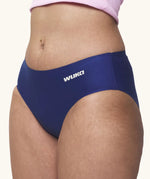 Side of model wearing the Wuka stretch teen midi brief seamless period pants in blue