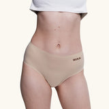 Front of model wearing the Wuka stretch midi brief seamless period pants in neutral