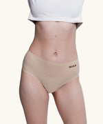 Front of model wearing the Wuka stretch midi brief seamless period pants in neutral