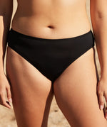 Front of woman wearing the WUKA swim bikini light flow period pants in black