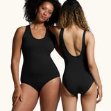 Two women wearing the WUKA Scoop Back Period Swimsuit. One showing the front of the swimsuit and the other showing the scoop back