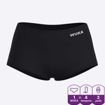 A person showing the stretch material of the WUKA Teen Stretch Boxer Shorts Heavy Flow - Black