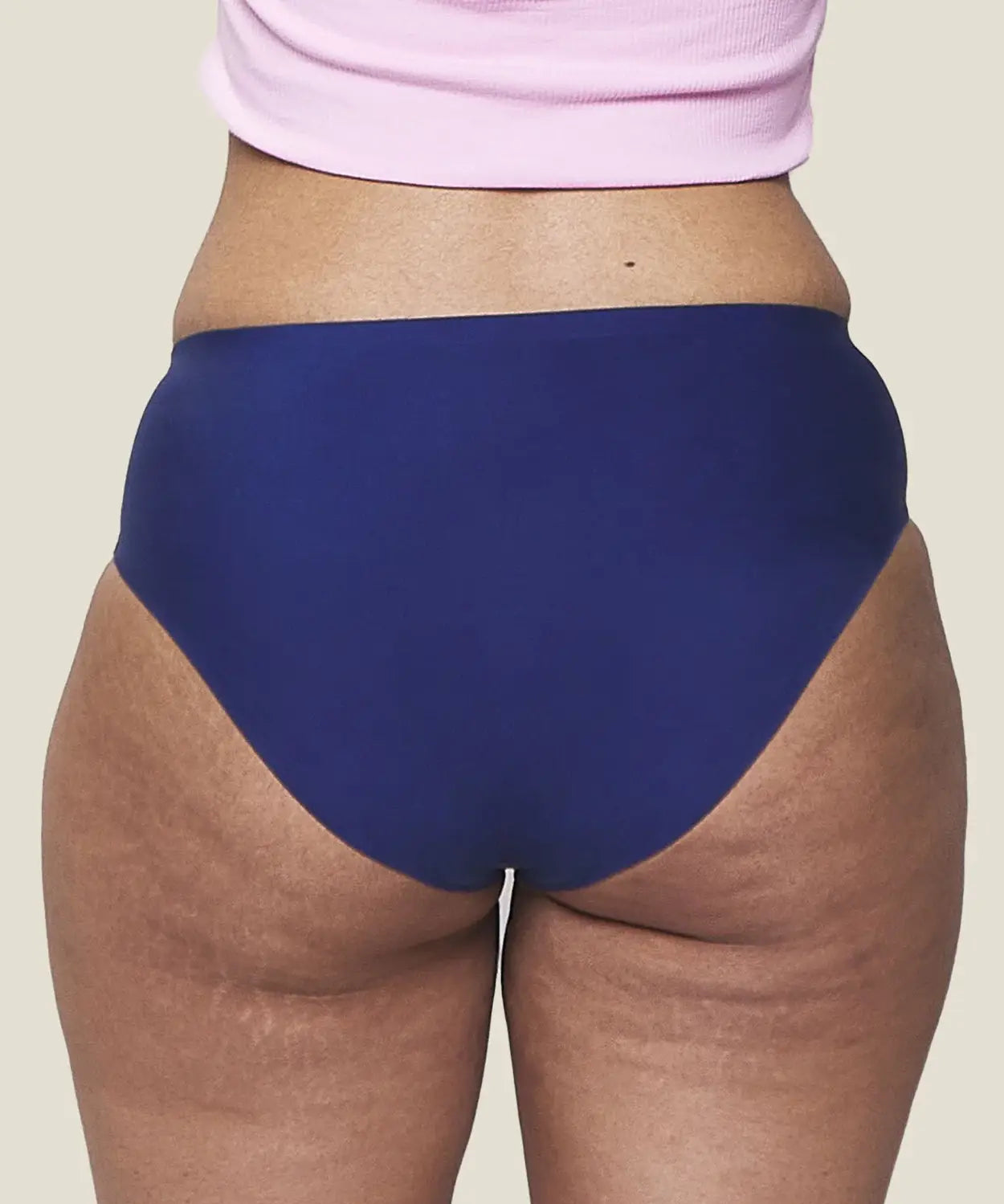 Back of model wearing the Wuka stretch teen midi brief seamless period pants in blue