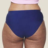 Back of model wearing the Wuka stretch teen midi brief seamless period pants in blue