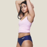 Front of model wearing the Wuka stretch teen midi brief seamless period pants in blue