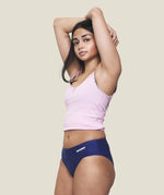 Front of model wearing the Wuka stretch teen midi brief seamless period pants in blue