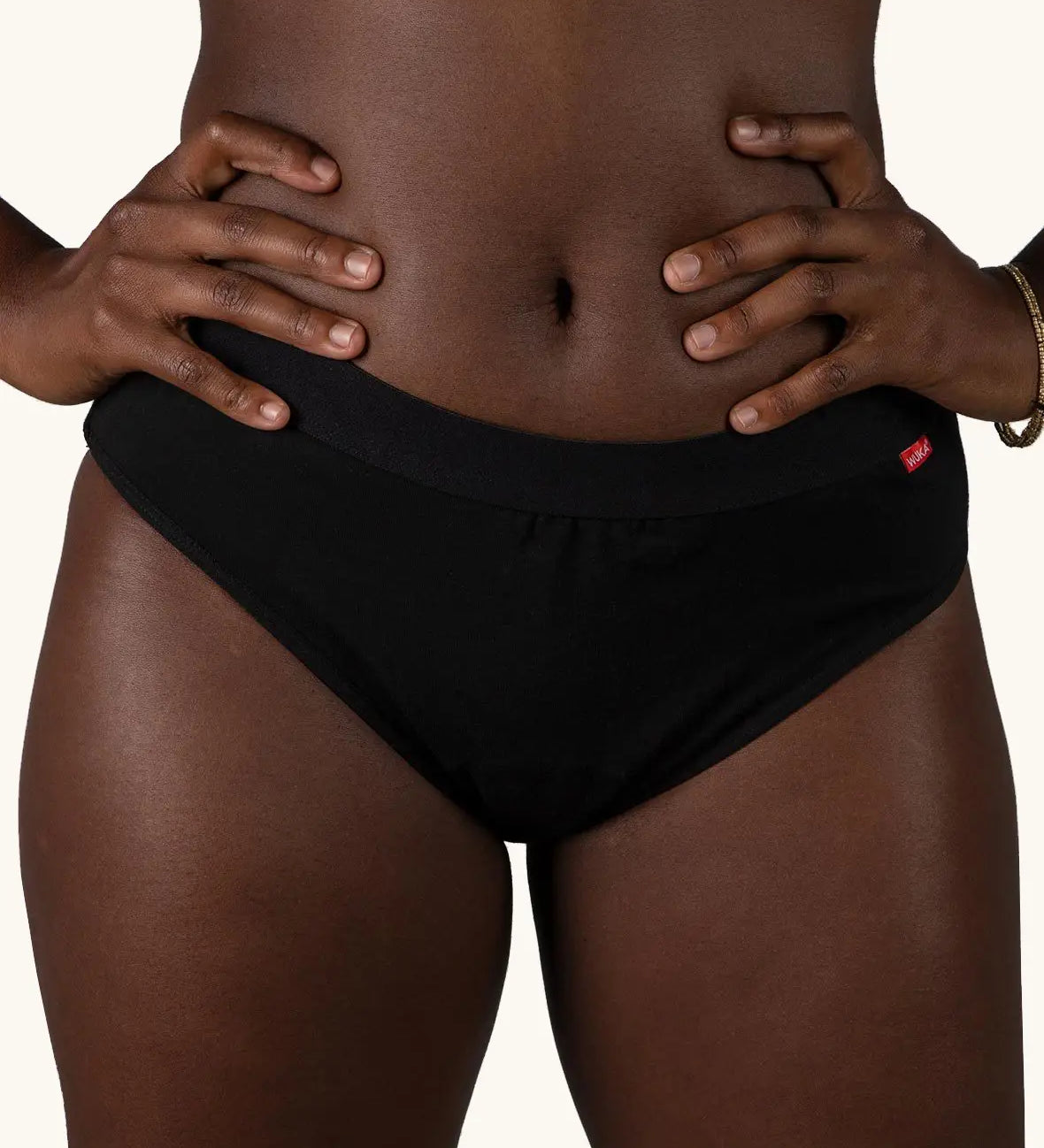 Front of woman wearing the Wuka ultimate bikini style medium flow period brief in black
