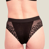 Back of woman wearing the Wuka ultimate lace midi medium flow period pants