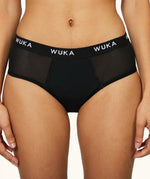 Front of woman wearing the WUKA reusable ultimate midi brief period pants 