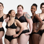 Women stood in a line wearing the WUKA eco-friendly midi brief sanitary underwear on a white background