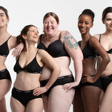 Women stood in a line wearing the WUKA eco-friendly midi brief sanitary underwear on a white background