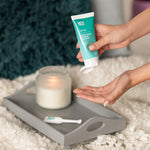 A hand squeezing some YES natural water based lubricant out of the tube.