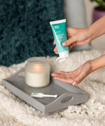 A hand squeezing some YES natural water based lubricant out of the tube.
