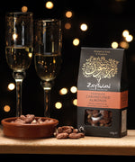 Zaytoun Fairtrade Palestinian caramelised Almonds in the box picured next to a bowl filled with the almonds. We are proud stockists of Zaytoun olive oil and produce here at Babipur. 