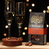 Zaytoun Fairtrade Palestinian roasted chilli Almonds packet pictured next to a bowl filled with the flavoured almonds. We are proud stockists of Zaytoun olive oil and produce here at Babipur. 
