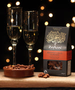 Zaytoun Fairtrade Palestinian roasted chilli Almonds packet pictured next to a bowl filled with the flavoured almonds. We are proud stockists of Zaytoun olive oil and produce here at Babipur. 