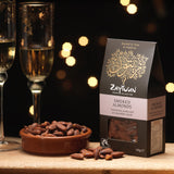 A packet of Zaytoun Fairtrade Palestinian Smoked Almonds next to bowl filled with them. We are proud stockists of Zaytoun olive oil and produce here at Babipur. 